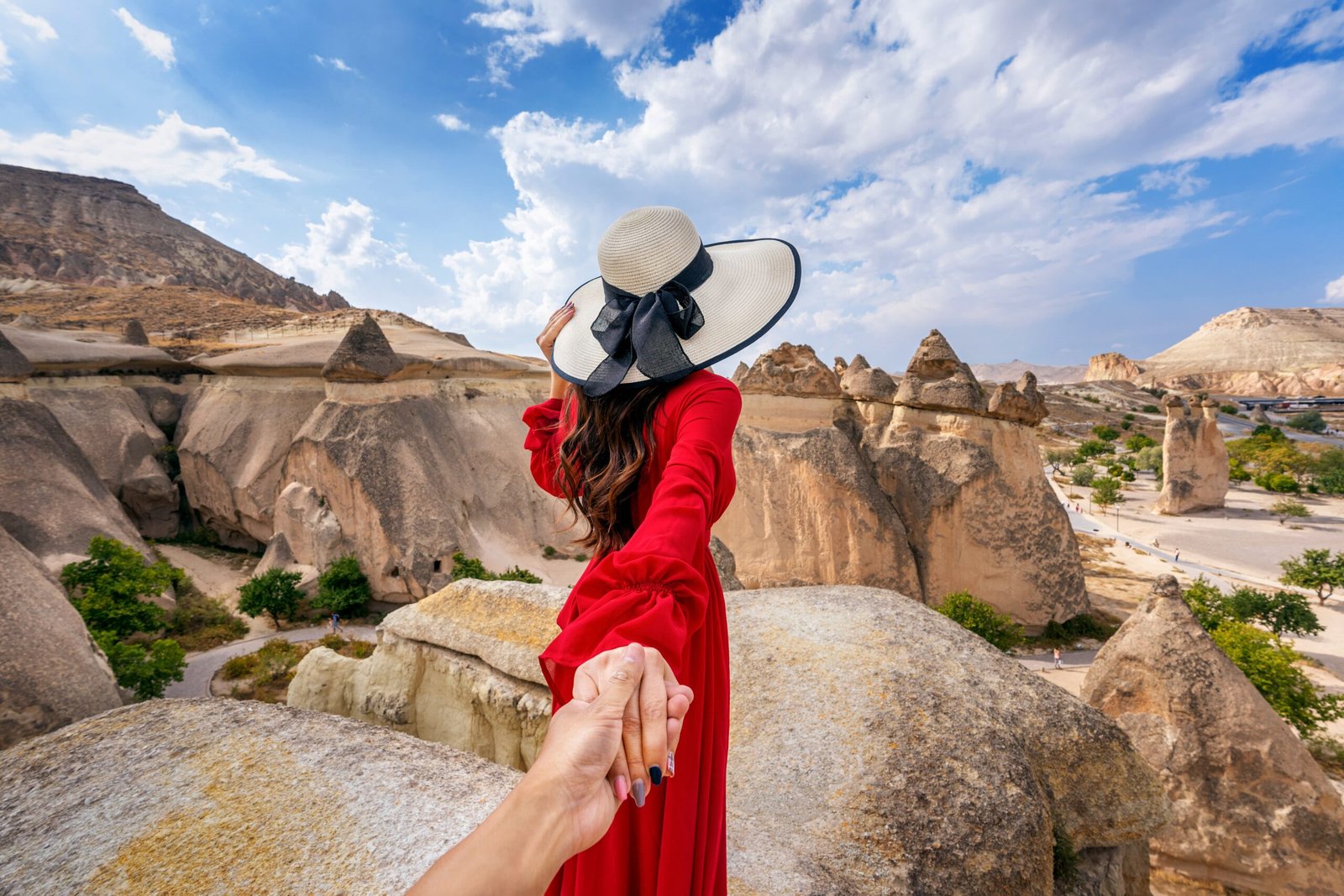 women-tourists-holding-man-s-hand-leading-him-fairy-chimneys-cappadocia-turkey (1)