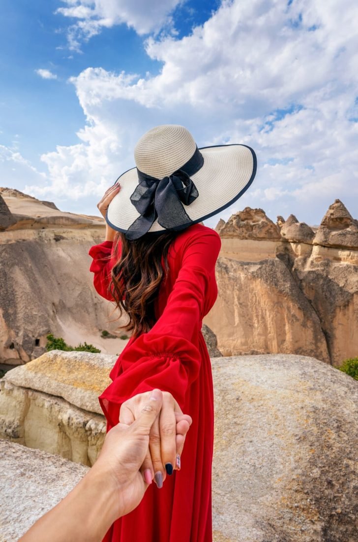 women-tourists-holding-man-s-hand-leading-him-fairy-chimneys-cappadocia-turkey (1)